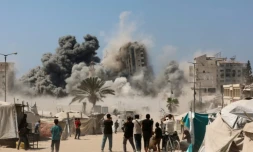 Des Palestiniens assistent à la destruction de la tour Mushtaha dans le centre de Gaza-ville, lors d'un bombardement israélien le 5 septembre 2025 ( AFP / Omar AL-QATTAA )