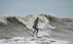 La surfeuse bangladaise Fatima Akhter pratique son sport à Cox's Bazar, dans le sud-est du Bangladesh, le 22 juin 2026  