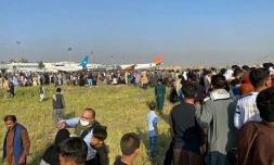 Des Afghans attendent à l'aéroport de Kaboul de pouvoir quitter la capitale, le 16 août 2021