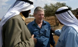 L'écrivain israélien Amos Oz discute avec des Palestiniens après la récolte d'olives à Aqraba, en Cisjordanie, le 30 octobre 2002