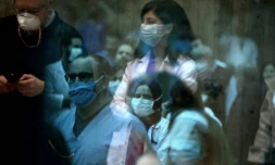 L'équipe de soignants de l'hôpital Saint-George à Beyrouth écoute un groupe de musique qui se produit pour eux, à travers une paroi vitrée, le 24 avril 2020