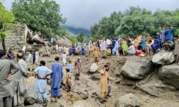 Des personnes se rassemblent sur le site d'une crue soudaine après de fortes pluies de mousson à Salarzai Tehsil, dans le district de Bajaur au Pakistan, le 15 août 2025