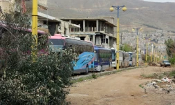 Un convoi de bus entre dans la ville rebelle de Zabadani, au nord-ouest de Damas, pour une opération d'évacuation de civils et combattants, le 12 avril 2017 en Syrie