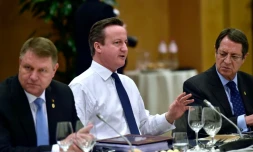 Le premier ministre britannique David Cameron (c) entre les présidents roumain Klaus Werner Iohannis (g) et chypriote Nicos Anastasiades (d) lors d'un dßner des dirigeants européens à Bruxelles le 19 février 2016