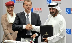 Le président de la compagnie Emirates, cheikh Ahmed ben Saïd Al-Maktoum (R), et le président d'Airbus, Guillaume Faury, se serrent la main aprÚs la signature d'un contrat au Dubaï Airshow le 18 novembre
