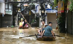 Des habitants se déplacent sur des embarcations après des inondations provoquées par le passage du typhon Yagi,  à Hanoi le 12 septembre.

