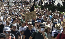 Un manifestant tient une pancarte lors d'une journée nationale de protestation contre le vaccin obligatoire pour certains travailleurs, et le pass santé demandé par le gouvernement français, à Nantes, le 14 août 2021