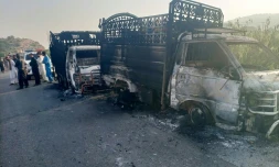 Des personnels de sécurité près de véhicules incendiés après une atttaque dans le district de Musakhail, dans la province du Baloutchistan, le 26 août 20244 au Pakistan