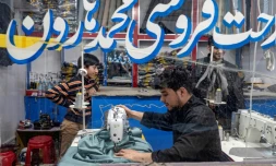 Un tailleur afghan (c) coud des vêtements avant l'Aïd al-Fitr, marquant la fin du mois de jeûne du ramadan, dans un atelier à Kaboul, le 7 avril 2024