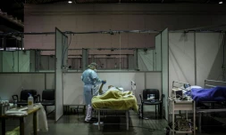 Un soignant traite un patient dans un centre sportif reconverti en hÎpital de campagne à Portimao au Portugal le 9 février 2021