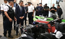 Le ministre de l'Intérieur français (4e à g) devant des deux-roues saisis par la police après des rodéos urbains à l'hôtel de police de Créteil, le 17 août 2022
