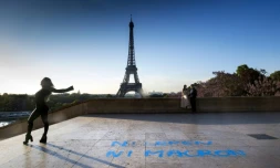 Un couple pose au Trocadero devant la tour Eiffel à Paris, sur le sol est inscrit le slogan "ni Le Pen ni Macron", le 27 avril 2017