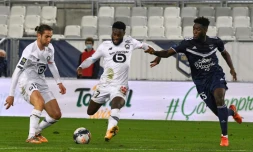 L'attaquant de Lille, Jonathan Bamba, tire au but sous les yeux du défenseur de Bordeaux, Enock Kwateng, lors de leur match de L1, le 3 février 2021 au stade Matmut Atlantique à Bordeaux