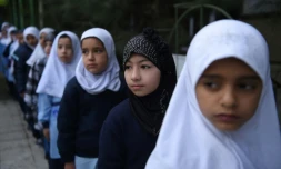 Dunya (2nd R) and her classmates are returning to school after more than two-months of holiday