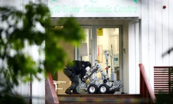 Un policier norvégien manipule un robot aprÚs la fusillade dans un mosquée prÚs d'Oslo, à Baerum, le 10 août 2019