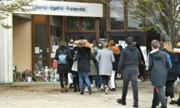 Adultes et enfants viennent déposer des fleurs devant l'école de Conflans-Sainte-Honorine, le 17 octobre 2020 au lendemain de la décapitation d'un des professeurs