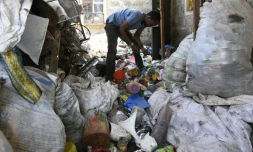 L'artiste kényan Evans Ngure cherche des matériaux dans des poubelles à Nairobi, le 2 août 2018