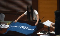 La nouvelle députée Yau Wai-ching déplie un drapeau sur lequel on peut lire "Hong Kong n'est pas la Chine" lors de sa prestation de serment au "Parlement", le 12 octobre 2016 à Hong Kong
