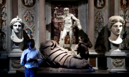 A very modern lab rat perches on Hirst's massive sandalled foot sculpture