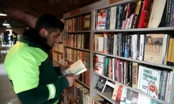 Un homme lit un livre dans une bibliothèque créée par des éboueurs d'Ankara, le 9 janvier 2018
