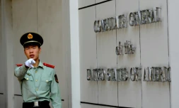 Un policier chinois pointant du doigt les journalistes devant le consulat américain à Chengdu, sud-ouest de la Chine, le 18 septembre 2012