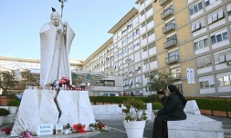Une none prie devant la statue de Jean Paul II, sur le parvis de l'hôpital Gemelli de Rome, dans lequel est hospitalisé le pape François, le 22 février 2025