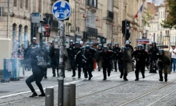 Des gendarmes mobiles chargent un manifestant pointant un mortier d'artifices vers eux pendant une manifestation lycéenne à Bordeaux, le 1er octobre 2026