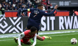L'attaquant du PSG Kylian Mbappé taclé par le Rémois Amir Richardson, au Parc des Princes, le 10 mars 2024