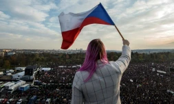 Une femme agite un drapeau en surplomb de la manifestation au centre de Prague de Tchèques qui réclament la démission de leur Premier ministre le 16 novembre 2019