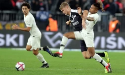 L'attaquant danois des Girondins Andreas Cornelius (c) à la lutte avec le Parisien Christopher Nkunku, le 2 décembre 2018 à Bordeaux
