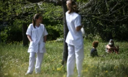Des infirmières (dont une assise, avec le masque) et une patiente dans le jardin de l'hôpital psychiatrique marseillais de Valvert, le 16 avril 2020