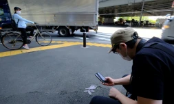 Le photographe japonais Koji Ishii prend en photo un gant perdu, le 25 mai 2020 Ă Tokyo