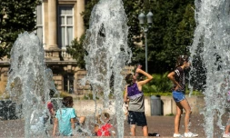 Des personnes se rafraßchissent sous les fontaines, le 24 août 2016 à Lille