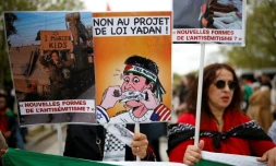 (ARCHIVES) Une personne brandit une pancarte sur laquelle on peut lire « Non au projet de loi Yadan » alors que des manifestants participent à un rassemblement contre ce projet de loi, qui vise à lutter contre les nouvelles formes d'antisémitisme, à Paris, le 12 avril 2026.