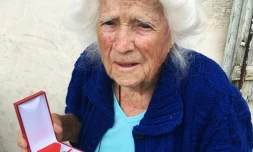 Geneviève Callerot, 102 ans, pose le 25 août 2018 à Saint-Aulaye (Dordogne), avec sa Légion d'honneur dont elle a été décorée pour avoir fait passer en zone libre réfugiés et juifs durand la 2nde Guerre mondiale  
