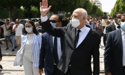 Dans cette photo publiée par la page Facebook officielle de la présidence tunisienne le 1er août 2021, le président Kais Saied (C)  marche lors d'une visite dans le centre de la capitale Tunis