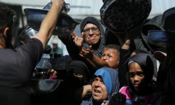 Nihaya Al-Masri (C), une Palestinienne déplacée lors d'une distribution alimentaire à Khan YounÚs, dans le sud du territoire palestinien, le 6 octobre 2026