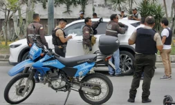 Des policiers autour du véhicule dans lequel le procureur Cesar Suarez a été assassiné par des hommes armés, le 17 janvier 2024 à Guayaquil, en Equateur
