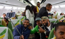 Des passagers posent dans l'avion des Ethiopian Airlines reliant Addis Abeba à Asmara le 18 juillet 2018. 
