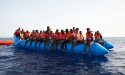 Photo prise et difffusée le 5 juillet 2019 par l'ONG allemande Sea-Eye montrant des migrants à bord d'un canot pneumatique surchargé repéré dans les eaux internationales au large de la Libye