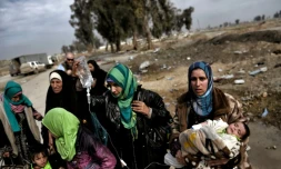 Des femmes et enfants fuient les combats à Mossoul entre les forces irakiennes et les jihadistes de l'EI, le 8 mars 2017