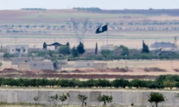 Un drapeau du groupe Etat islamique aperçu prÚs de la frontiÚre entre la Turquie et la Syrie, le 7 mai 2016