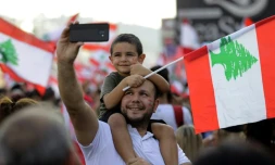 Un Libanais porte un enfant sur ses épaules, lors d'une manifestation contre le pouvoir à Zouk Mosbeh, au nord de Beyrouth, le 20 octobre 2019