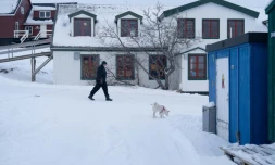 Une femme promène son chien dans le quartier du Vieux Nuuk, le 16 janvier 2026 à Nuuk, au Groenland