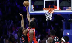Joel Embiid (Philadelphie) bloque un tir de Precious Achiuwa (Toronto) lors de la victoire des Sixers sur les Raptors en NBA, à Philadelphie, le 22 décembre 2023
