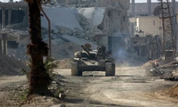 Un tank de l'armée syrienne avance dans l'ancienne localité rebelle de Beit Nayem dans la Ghouta orientale, le 6 mars 2018