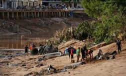 Des personnes tentent de dégager une voiture engloutie par la boue à la recherche de victimes, après les inondations qui ont frappé la région de Valence, le 1er novembre 2024 à Paiporta, en Espagne