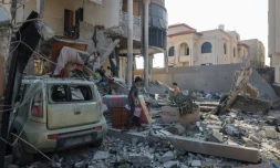 Les Palestiniens inspectent les dégâts causés par un bombardement d'une maison dans le camp de réfugiés de Nousseirat, dans le centre de la bande de Gaza, le 14 août 2024