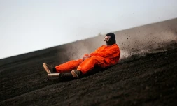 Un touriste descend sur une planche la pente du volcan Cerro Negro, le 22 mars 2022 au Nicaragua