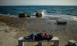 Un migrant allongé sur un banc sur la plage de Lesbos, le 3 mars 2020